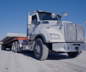 Roman Stone truck transporting engineered precast concrete solutions to an infrastructure project