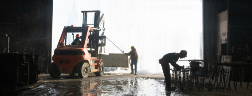 Roman Stone team manufacturing and handling engineered precast concrete components