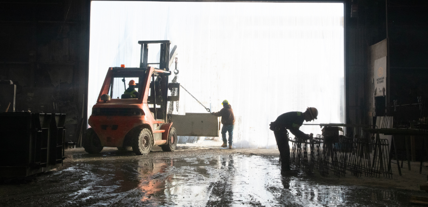 Roman Stone team manufacturing and handling engineered precast concrete components