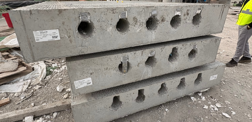 Custom precast concrete utility structure with specialized openings designed for infrastructure project requirements.