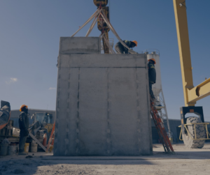 Precast concrete electrical vault being prepared for underground electrical infrastructure